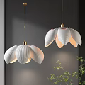 White Petal Shaped Pendant Lights With Golden Fixtures In Modern Interior With Green Plants