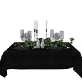 Elegant Tableware Set with Black Tablecloth Wine Glasses Candle Holders and Green Plants