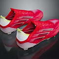 Red Athletic Soccer Shoes With White And Yellow Accents And Spiked Soles