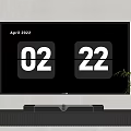 Modern TV Displaying April 2022 Date 02 22 On Black Stand With Plant