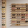 Various Styles of Multicolored Sunglasses Neatly Organized on Wooden Display Shelves