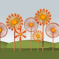Colorful Windmill Art Installation With Orange Yellow Blades In Green Grass Field