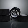 Car Tires Stacked With Metallic Wheel Rim On Dark Reflective Surface