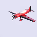 Red Passenger Airplane With Single Propeller And Black Edge Wings In Light Blue Sky
