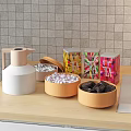 Beige Water Jug Colorful Tea Tins and Bowls with Candies Chocolate Bars on Kitchen Counter