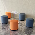 Round Upholstered Orange And Blue Stools With Small Table On Marble Floor 3d model