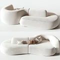 White Irregular Shaped Fabric Sofa With Curved Design And Decorative Pillows