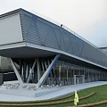 Modern Sales Office Building With Inclined Metal Facade And Glass Curtain Wall