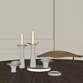 Sleek Modern Metallic Candle Holders With White Candles On Wooden Table And Minimalist Wall