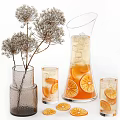 Refreshing Orange Beverage in Glass Pitcher and Cups with Ice Cubes Slices and Dried Flowers