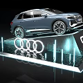 Audi Q4 e-tron Car on Display Platform with Illuminated Logo Blue Lighting and Water Reflection