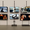 Multiple TVs Wall Mounted And On Stands Showing Different Video Scenes