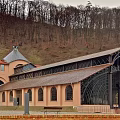 Modern Museum Architecture With Glass Facade Arched Roof And Green Hills