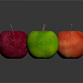 Four Colorful Apples in Yellow Red Pink and Green on Dark Background