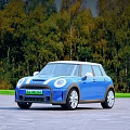 Blue Mini Cooper Car Parked On Paved Road Surrounded By Green Trees 3d model