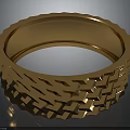 Golden Ring Shaped Household Item With Intricate Braided Surface Design