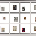 Multiple Framed Abstract Paintings With Diverse Artistic Designs On Wall