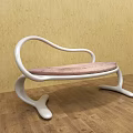 Modern Leisure Chair With White Curved Frame And Pink Cushioned Seat On Wooden Floor