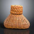Potted Plant In Handwoven Bamboo Basket With Natural Brown Weave Texture
