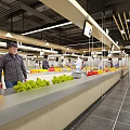 Modern Supermarket Fresh Produce Section With Orange Displays And Shoppers