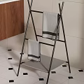 Black Metal Towel Rack With Gray Striped Towels And Shelf In Bathroom