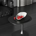 Elegant White Speckled Ceramic Vessel With Red Cherries On Black Coffee Table In Living Room