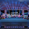 Eye Catching Stage Design With Colorful Lights Large Screens And MOMENT Text Elements