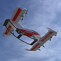 Red and White Rescue Aircraft With 112 Marking Flying in Blue Sky