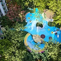 Vibrant Children's Play Area With Colorful Slide Swing And Lush Green Trees