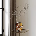 Golden Amber Glass Globe Vase Holding Silver Decorative Branches On Glass Table