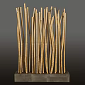 Stone and Wood Art Installation with Slender Vertical Wooden Sticks on Stone Base