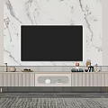 Stylish Striped TV Stand With Gold Legs And Decorative Items Against White Marble Wall