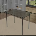 Modern Glass Top Dining Table With Silver Metal Legs Near Windows In Bright Indoor Space