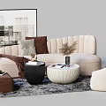 Beige Curved Sofa with Pillows Throw Blanket Round White Coffee Table and Black Table on Gray Rug