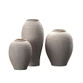 Three Gray Ceramic Vases with Floral Patterns and Textured Designs in Various Sizes