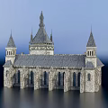 Ancient Medieval Stone Building With Gray Roof Arched Windows Towers And Spires