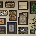 Diverse Framed Artworks With Various Patterns On Wall And Green Plant