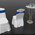 White Covered Dining Chairs With Blue Sashes And Small Round Table With Flower Decoration
