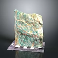 Large Natural Green and Yellow Textured Stone Decorative Piece on Checkered Mat with Dark Background