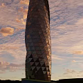 Modern Commercial Complex With Spiral Design And Diamond Shaped Glass Facade Against Sunset Sky