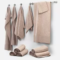 Light Brown Textured Towels Hanging On Wall With Rolled Towels And Soft Finish