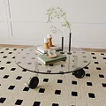 Round Glass Top Coffee Table with Black Wheels on Black White Square Rug Books Candles