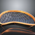Curved Furniture Cushion With Orange Frame And Dark Diamond Textured Surface On Stand