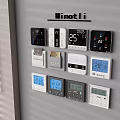 Various Black And White Switch Panels With Digital Temperature Displays On Grey Wall