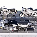 Three Different Motorcycles Parked On Brick Paved Area With White Stripes