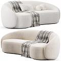 Light Colored Upholstered Two Seater Sofa With Rounded Design And Plaid Blanket 3d model