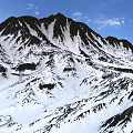 Scenic Snowy Mountain Peak Landscape With Blue Sky And White Clouds
