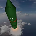 Green Missile Flying With Rocket Exhaust Over Ocean And Land Under Cloudy Sky