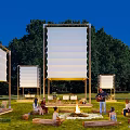 Night Garden Landscape With Large Screens Bonfire And People Gathering On Lawn