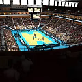 Vibrant Basketball Arena With Full Seated Spectators And Active Game On Court